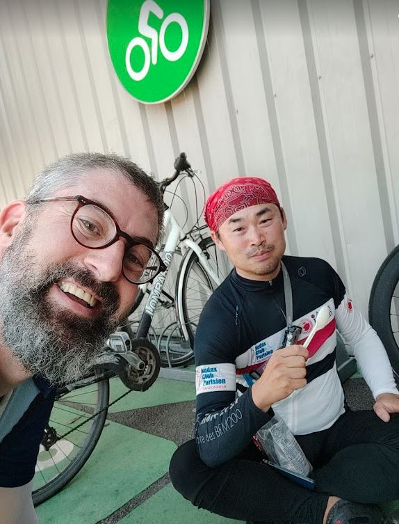 A Japanese rider and I sharing space in the car park of a French Supermarket
